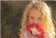 Girl smelling flower