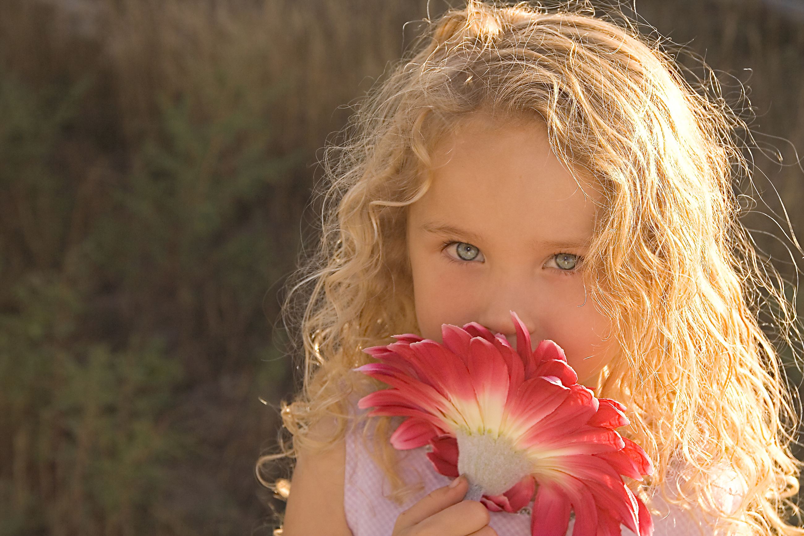 Girl smelling flower